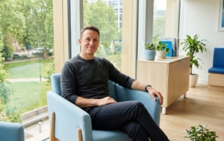 Patient in modern clinic showing confidence after PRP therapy for tennis elbow treatment consultation