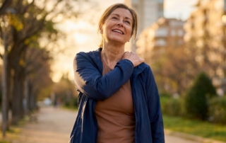 Person moving shoulder freely outdoors, representing recovery through shoulder bursitis injection treatment options.